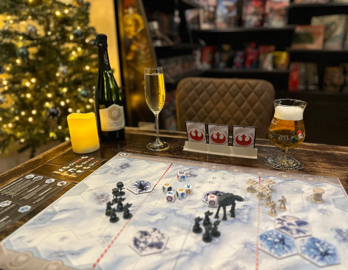 Board game setup with Star Wars theme on a table with drinks and Christmas decorations.