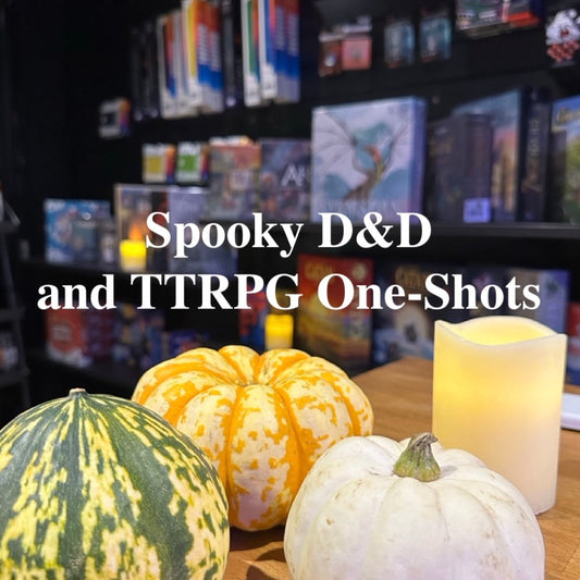 Promotional graphic for 'Spooky D&D and TTRPG One-Shots' featuring three decorative pumpkins (one green and yellow marbled, one orange and yellow speckled, one white) and a glowing cream-colored candle on a wooden table, with a blurred background of bookshelves filled with books and game boxes.
